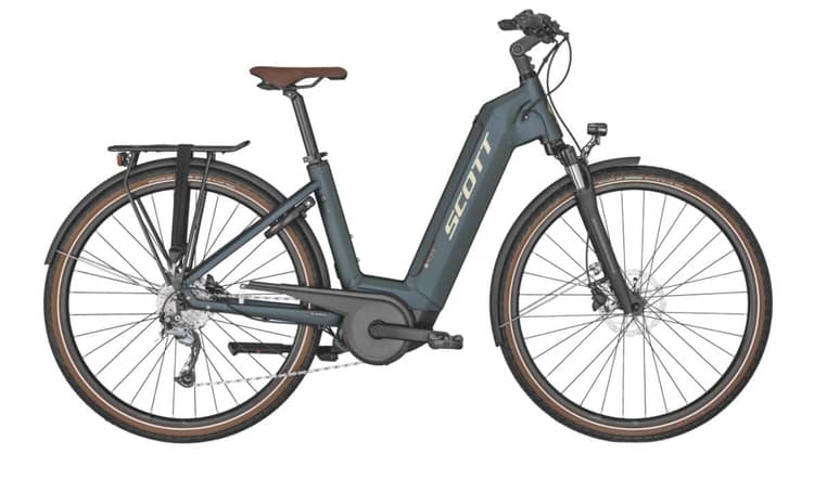 Green Scott Sub Active electric bike with low-step frame and rear carrier, parked on a white background.