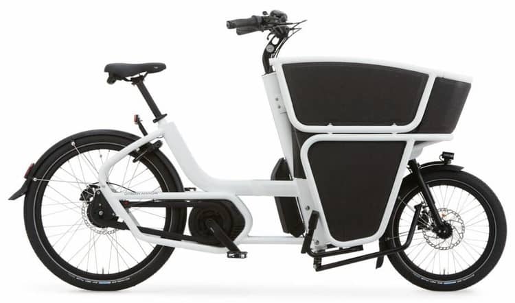 Black electric cargo bike with front basket, step-through frame, and sturdy kickstand on a white background.