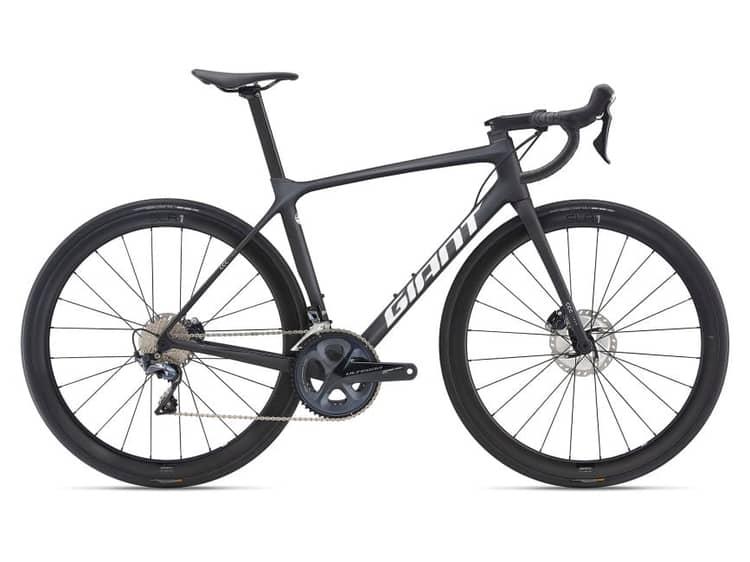 A sleek black Giant road bicycle with aerodynamic frame, integrated cabling, disc brakes, and deep-section wheels.