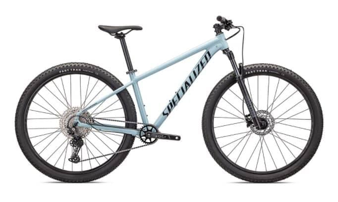 Modern brown Rockhopper mountain bike with black trim and large knobby tires, parked on a white background.