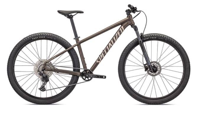 Modern brown Rockhopper mountain bike with black trim and large knobby tires, parked on a white background.